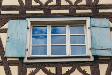 Fototapeta na wymiar European house windows with shutters