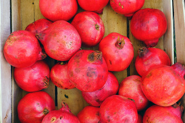 Crate of fresh red pomegranate fruit