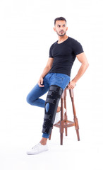 Naklejka premium man wearing supportive leg brace in studio with white background