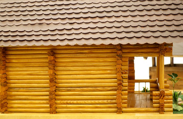 New house of wooden bars with a tiled roof.