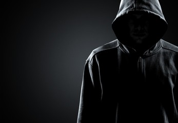 Fototapeta na wymiar Thief in black clothes on grey background