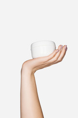cropped view of woman holding hand cream isolated on white with copy space