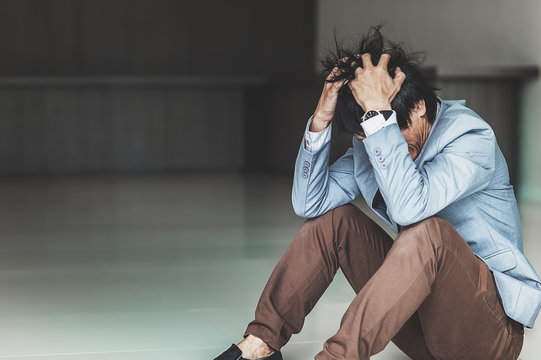 Bankrupt of Asian businessman is sitting at his workplace,Young businessmen are stressed and pressured that the business is damaged,selective focus,Overwork and fallibility concepts