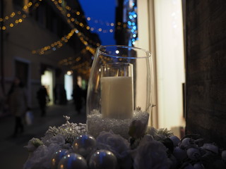 Christmas time, candle and Christmas ornament in the street.