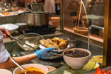 Chef cooking seafood in the hotel kitchen