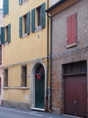 Old wooden door with Christmas ornament.