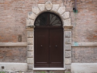 Ferrara, Italy. Facade and old door.