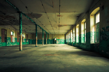 Dark interior inside abandoned old factory building 