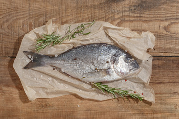 Healthy food clean eating selection: fruit, vegetable, seeds, fish, meat, leaf vegetable on wooden background. Top view.