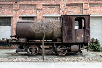 Fototapeta na wymiar Old black lokomotive in Żyrardow (Poland) covered with rust.
