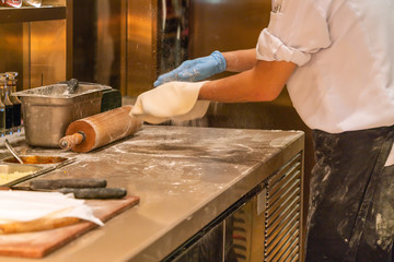 Chef making pizza in the restaurant kitchen