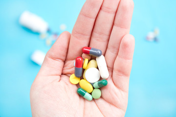 Colorful pills and medicines in the hand 