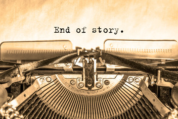 end of story printed on a piece of paper on a vintage typewriter. journalist, writer. - Powered by Adobe