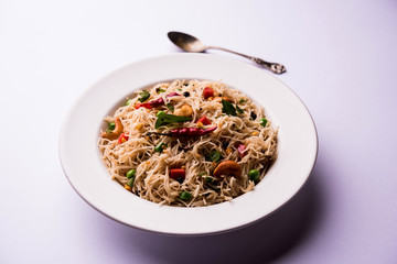 Semiya Upma or Vermicelli Uppuma or uppittu is a popular breakfast menu from south India. served in a bowl. selective focus