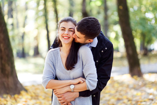 Natural photos of a happy couple in love having fun outside on a sunny autumn day. Togetherness and happiness concept