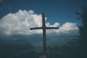 The cross with nature in the forest on the hill is the Blackground.