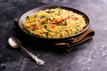 Semiya Upma or Vermicelli Uppuma or uppittu is a popular breakfast menu from south India. served in a bowl. selective focus