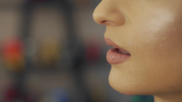 Visagiste using brush for application lipstick on lips makeup model. Close up application lip gloss. Makeup artist doing makeup lips. Beauty and fashion concept