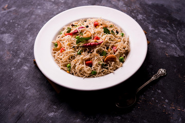 Semiya Upma or Vermicelli Uppuma or uppittu is a popular breakfast menu from south India. served in a bowl. selective focus