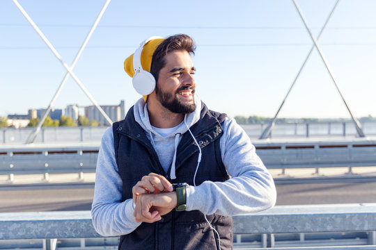 Fitness man watching at smartwatch