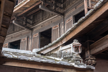 Traditional chinese carvings on roof at Tulou at Unesco heritage site near Xiamen