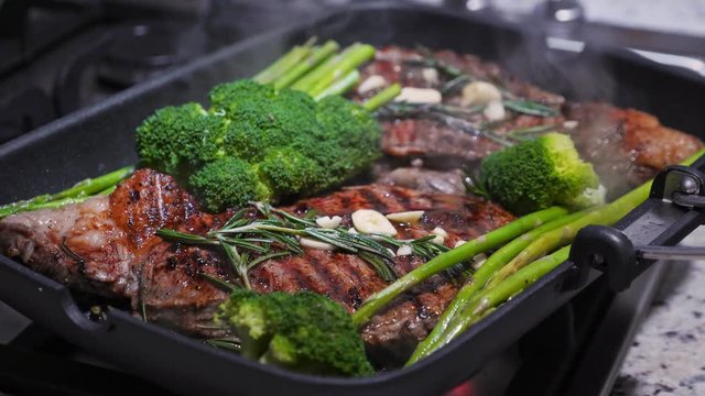 Cooking beef on grill frying pan on gas oven, closeup