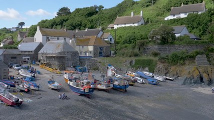 The sun comes out from behind the clouds in beautiful Cadgwith Cove, Cornwall.