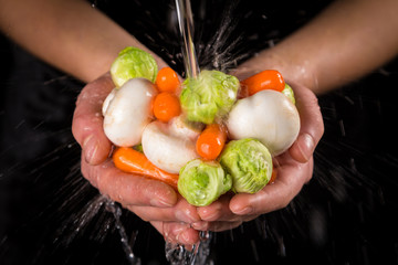 Washing the vegetables in woman hands