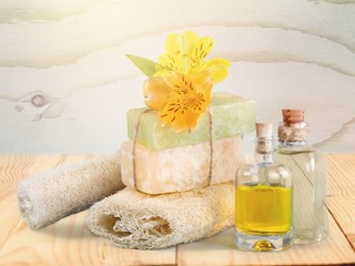 Obraz na płótnie Canvas Healthy spa concept with handmade soap bars, oil bottles, sponge
