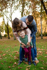 Fototapeta premium Happy family resting in beautiful autumn park