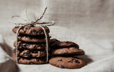 Festive chocolate cookies on linen fabric background