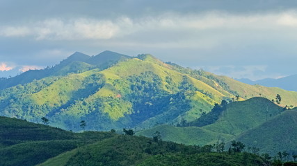 Fototapeta premium view of Khao Chang Puek known as white elephant mountain, beautiful green forest and high mountain with cloudy sky background, Thong Pha Phum National Park, Thong Pha Phum, Kanchanaburi, Thailand.