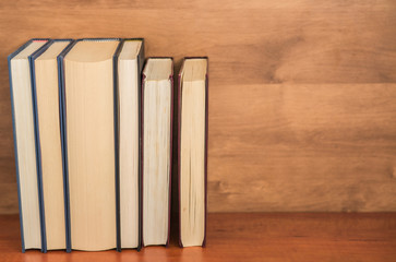 Pile of closed books on  wooden background