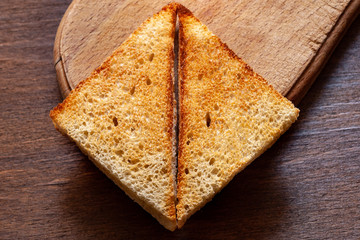 Slices of toast bread on a wooden background