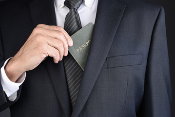 Closeup of a business man taking his passport for his suit  jackets inside breast pocket.