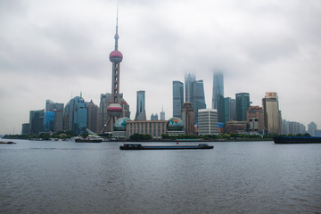  Shanghai / China - may 22 2017: Shanghai skyline on a cloudy day with the skyscrapers covered in louds and mist 