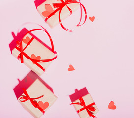 Valentine's Day gift on a pink background lie with a red ribbon hearts with love frame place for text isolate
