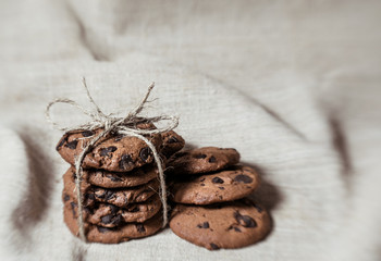 Festive chocolate cookies on linen fabric background