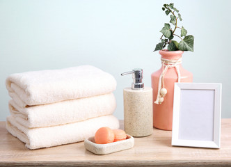 Stack of folded towels.Bathroom objects with frame.Body care items.