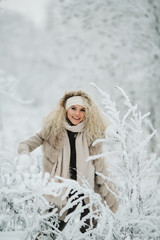 Portrait of blonde woman on walk in winter forest