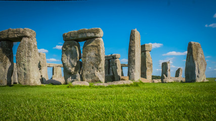 Naklejka premium Stonehenge unesco world heritage site near Salisbury in England. Summer holidays destination in the UK, Europe. View of stone archways at Stonehenge in British countryside on a sunny day, England.