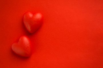 Red background with red hearts, there is a place for text.