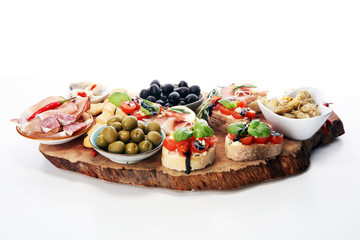 Italian antipasti wine snacks set. Cheese variety, Mediterranean olives, pickles, Prosciutto di Parma, tomatoes, artichokes