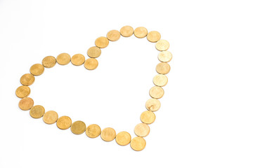 Close up view of new indian coins on white background. Heartshape concept.