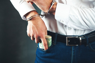 man pocket handcuffs with money