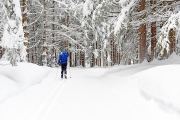 Cross-country skiing. Young man doing outdoor exercise. Winter sport and healthy lifestyle.