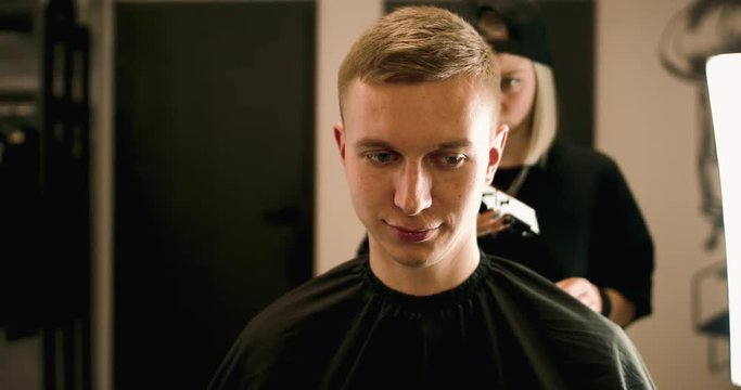 Handsome Man getting a haircut in a modern barber shop. 4K Footage Raw edited. - Video
