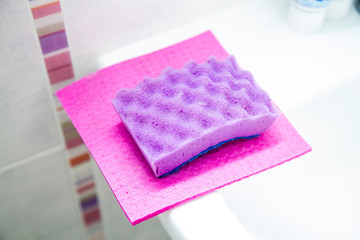 Obraz na płótnie Canvas bright washcloths for washing dishes on a light background