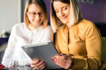 women using digital tablet at home