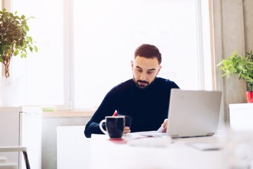 Caucasian young man working on laptop